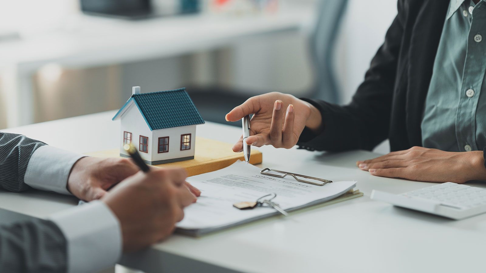 Close up Business woman or Real Estate agent explain signing agreement for buying house
