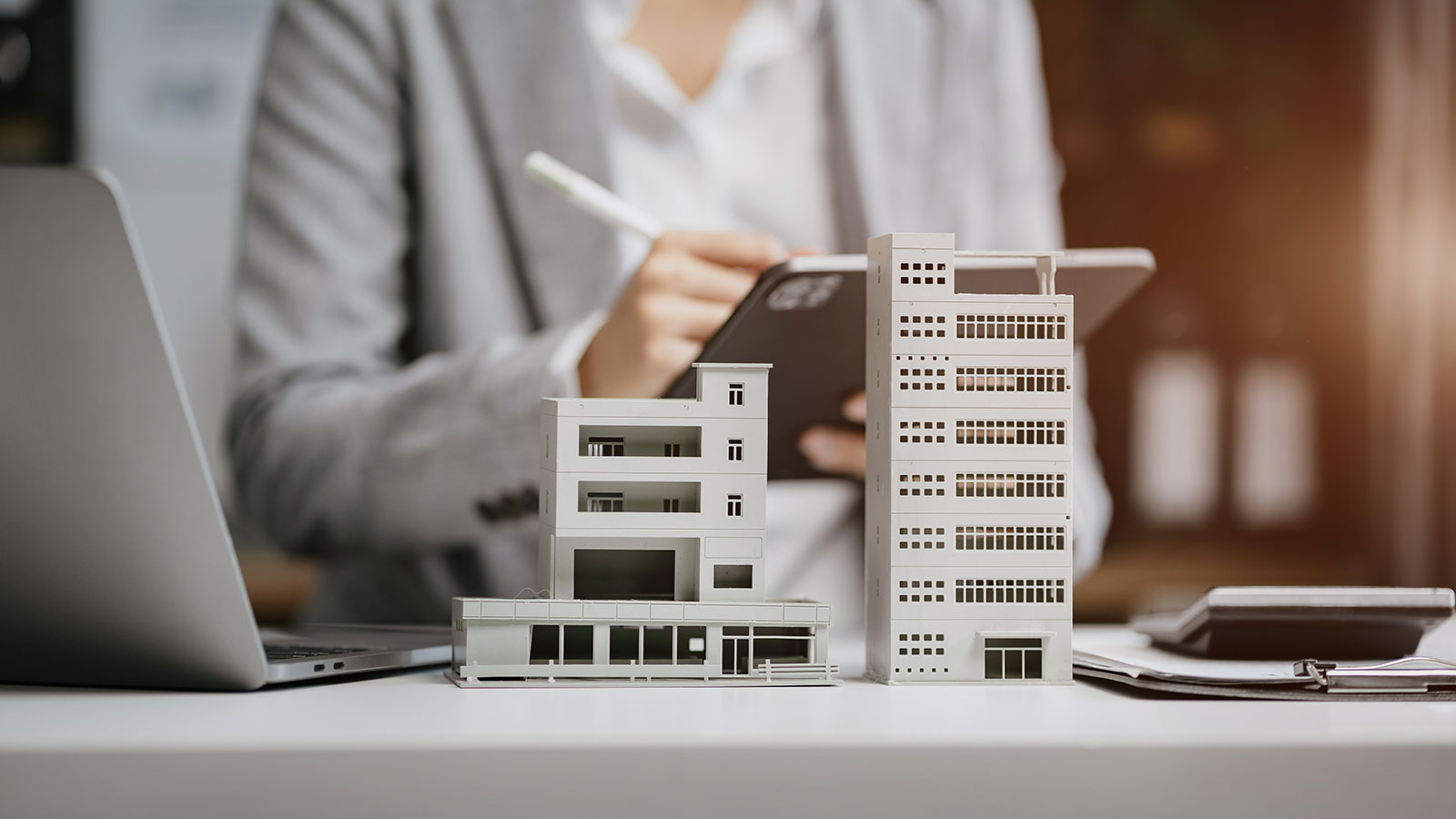House model with agent asking costumer for contract to buy, get insurance or loan real estate or property.